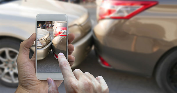 Person taking photo of car accident