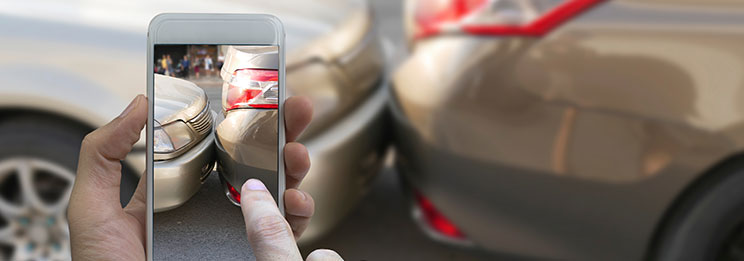 Person taking photo of car accident