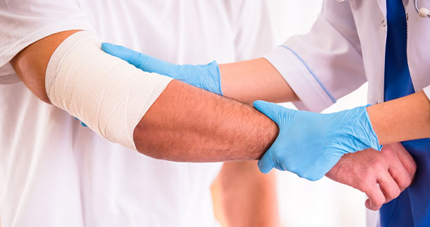 doctor holding injured person's arm