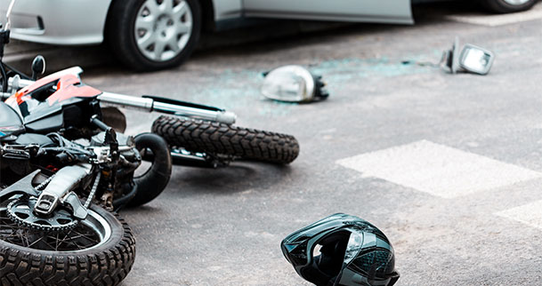 motorcycle laying in road after crash