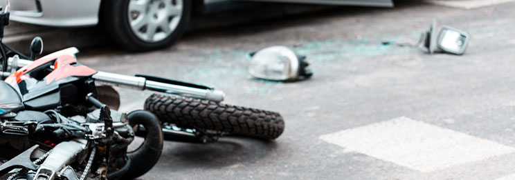 motorcycle laying in road after crash